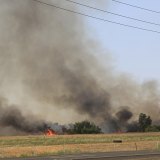 More smoke and flames at site of fire.